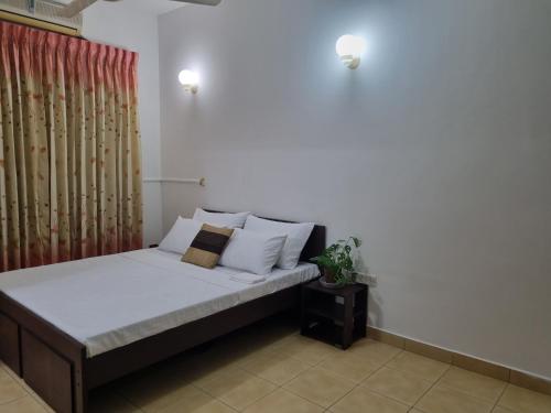 斯里贾亚瓦德纳普拉科特M-stay Colombo的一间卧室配有带白色床单和枕头的床。