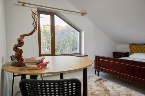 阿拉木图Sweet Vibe Home的客房设有桌子、床和窗户。