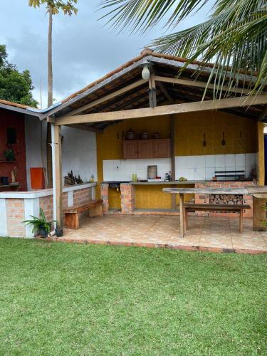 贝伦Pousada completa em Mosqueiro的房屋的庭院,配有桌子和长凳