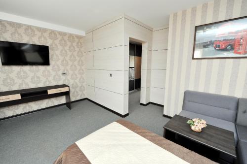 AksayОтель Бестау的一间酒店客房,配有一张床和一台电视