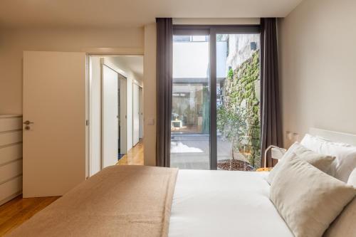 布拉加Yellow Lodge - Minho's Guest的一间卧室设有一张床和一个大窗户