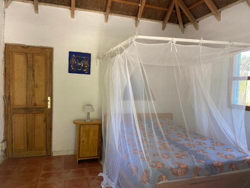 Mar LodjBazouk Du Saloum Ecolodge的一间卧室配有一张带蚊帐的床