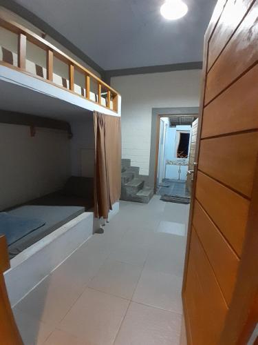 巴图卡拉anik homestay & dormy Batukaras的带双层床的客房和走廊
