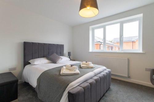 StaveleyAll Inn Apartments的一间卧室配有一张大床和毛巾