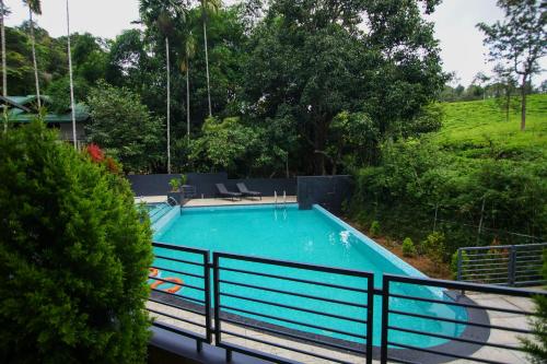 瓦亚纳德B'camp Resorts & Homestays的一个带围栏的院子内的游泳池