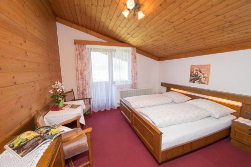 卡普伦贝尔格布里克旅馆的木制客房内的一间卧室配有两张床