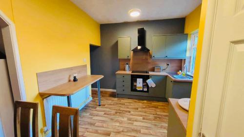 威根The Smart Stay - sleeps 5 Wigan central location的厨房设有黄色和蓝色的墙壁和柜台