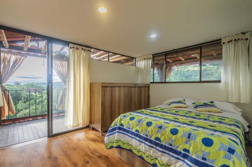 马尼萨莱斯Kairí Lodge Natural Reserve的一间卧室设有一张床和一个大窗户