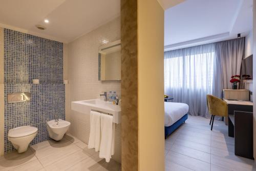 丹吉尔肯兹索拉祖尔酒店的一间带水槽和卫生间的浴室以及一张床