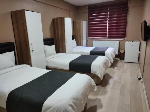 宗古尔达克ONKA OTEL的酒店客房设有三张床和窗户。