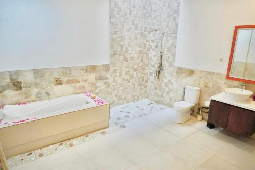 库塔Private 3- bedroom Villa with pool.的带浴缸、卫生间和盥洗盆的浴室