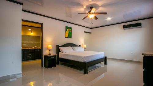 福尔图纳Chachagua Suites & Villas的一间卧室配有一张床和吊扇