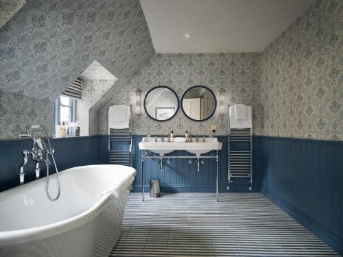马姆斯伯里Townhouse Suites- Abbey Row的带浴缸、水槽和镜子的浴室