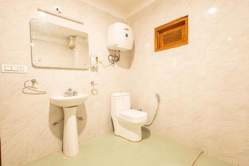 马拉里Aroha Residency- A Countryside Resort的白色的浴室设有卫生间和水槽。