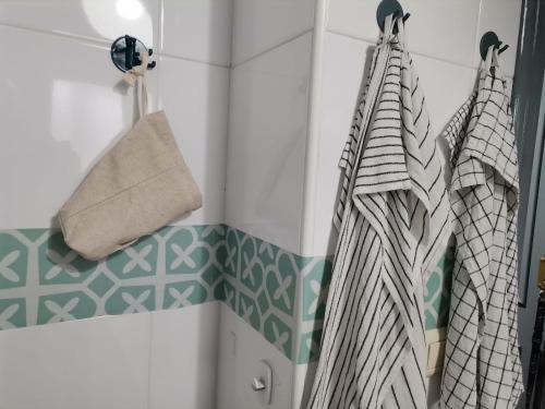 阿尔梅利马Villa Pepita的浴室铺有绿色白色瓷砖,配有毛巾。
