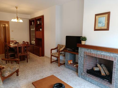 坎普罗东Muralla的客厅设有壁炉和电视。