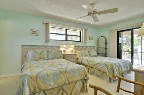 伊斯拉莫拉达Villa Riolo的一间卧室配有两张床和吊扇