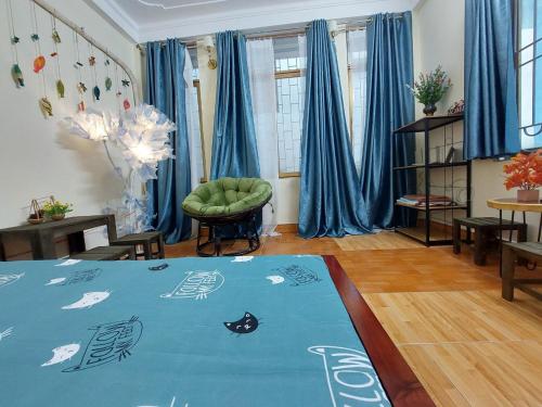 河内alleyhomestay 2的客厅配有蓝色窗帘和蓝色地毯。