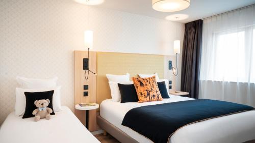 塞里斯塞祖尔阿菲尔塞利左岸酒店的酒店客房设有两张床,上面有泰迪熊