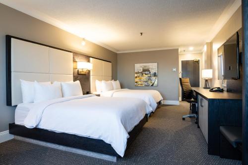蒙克顿蒙克顿市区皇冠假日酒店的酒店客房配有两张床和一张书桌