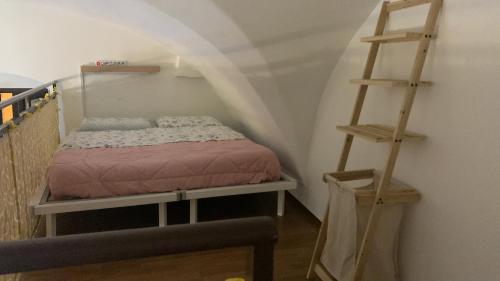 孔韦尔萨诺Dimora maria的小卧室设有一张床和梯子