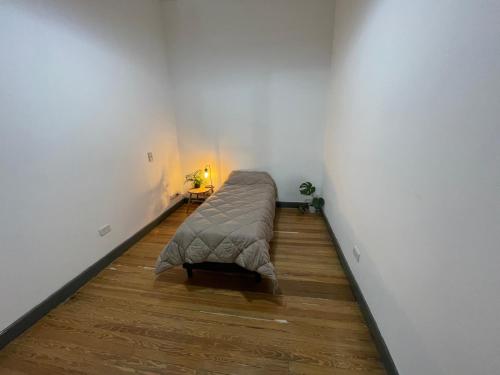 萨尔塔DOS SANTOS HOSTEL的一间位于客房角落的带一张床的房间