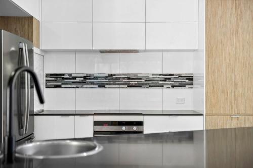 佩里吉安比奇252 David Low Way的厨房配有白色橱柜和不锈钢盥洗盆