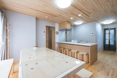 福冈Hinoki house的厨房设有木制天花板和木桌。