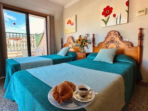 福恩吉罗拉雷耶索尔酒店的一间酒店客房,配有两张床和一个带咖啡的托盘