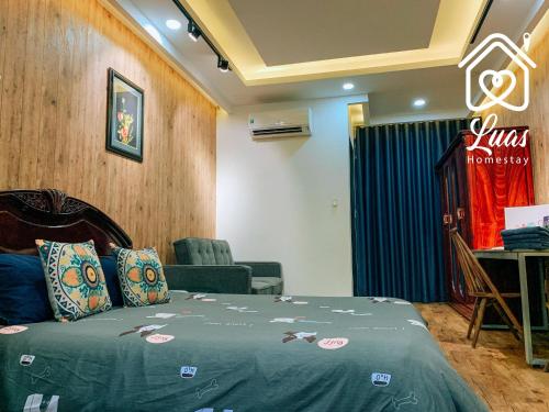 胡志明市Luas Cosy Home - The Cosy Chinatown Hideaway的酒店客房带一张床、一张桌子和椅子