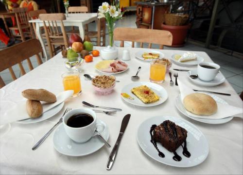 瓦尔帕莱索Hotel Cabernet的餐桌,盘子上放着食物和咖啡