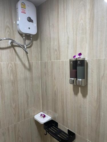芭东海滩My Home的浴室配有带吹风机的卫生间,墙上设有吹风机。