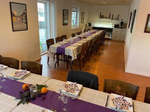 维堡维伯格汽车旅馆的用餐室配有带紫色桌布的长桌