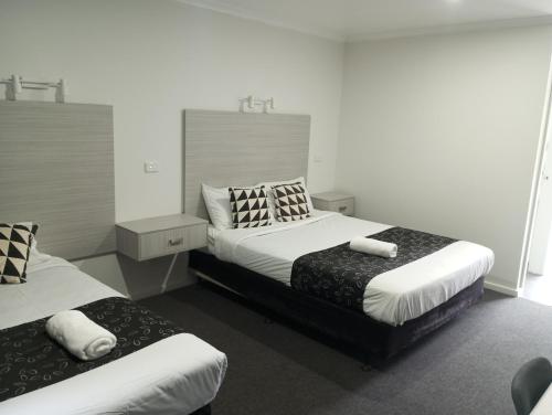 谢珀顿大山谷湖畔乐园汽车旅馆 的一间卧室配有两张带枕头的床。