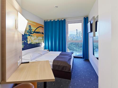科隆科隆博览会B&B酒店的酒店客房配有一张床铺和一张桌子。