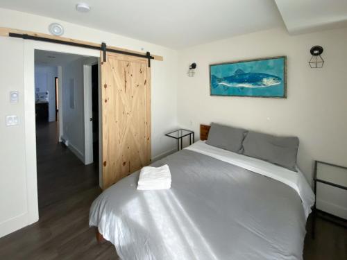 埃德蒙顿Calming 1bedroom Units With Balcony And City View的卧室配有一张床,墙上挂有鱼画