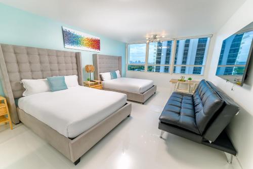 迈阿密海滩SeaStays Apartments的一间卧室配有一张床、一张沙发和窗户。