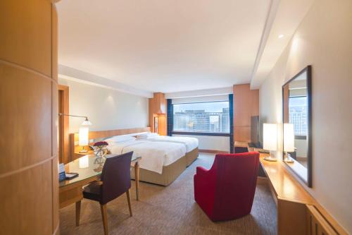 迪拜迪拜海滨大道凯悦酒店的酒店客房,配有一张床、一张桌子和椅子