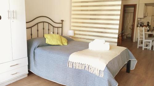蒙得维的亚Monoambiente céntrico的一间卧室配有一张黄色枕头的床