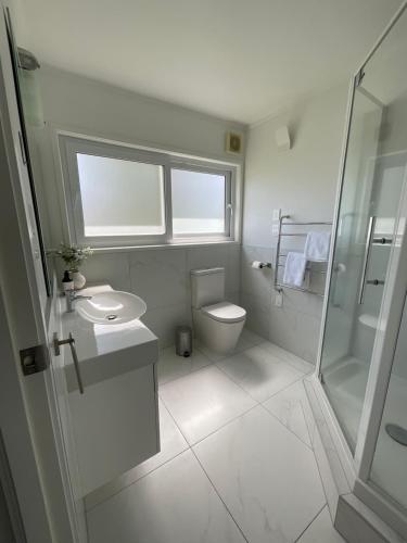 奥克兰Central Howick Uxbridge Apartments的浴室配有卫生间、盥洗盆和淋浴。