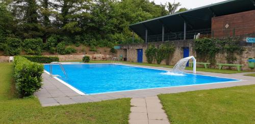 埃希特纳赫Camping Officiel Wollefsschlucht Echternach的一个带喷泉的大型蓝色游泳池
