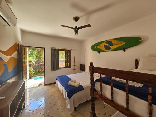 阿布拉奥Raio de Sol pousada & camping的卧室配有一张床,墙上设有冲浪板