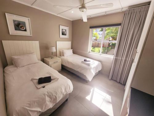 爱德华港Caribbean Estates-Montego Bay 12的一间卧室设有两张床和窗户。