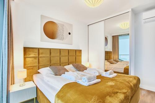 米兹多洛杰Wave Panorama Apartment - Sea View&SPA的一间卧室设有两张床和大镜子