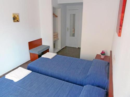埃尔阿雷纳尔Hostal Sol de Mallorca的配有蓝色床单的客房内的两张床