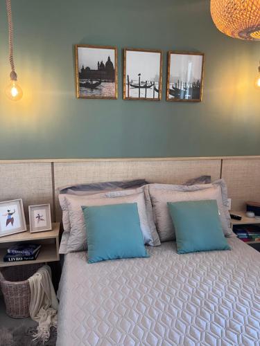 里贝朗普雷托Fiusa Dream 153的卧室配有一张墙上三幅照片的床