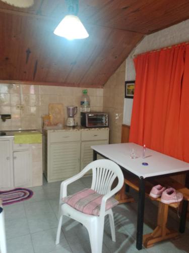 阿加斯杜尔斯Alvaro的厨房配有桌子、白色椅子和桌子