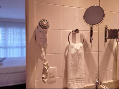 巴西利亚Hotel Vision的墙上配有吹风机的浴室