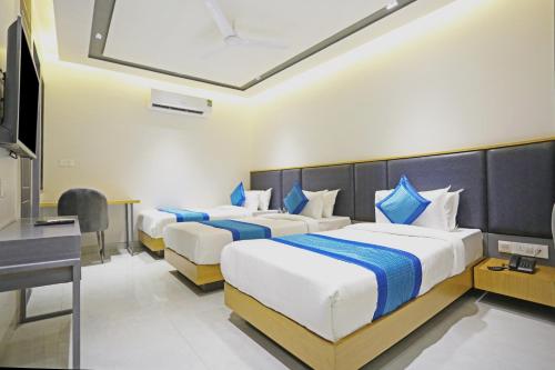 新德里Hotel Apple Villa - Near Delhi Airport with Free Airport Transsfer的酒店客房配有两张床和一张书桌