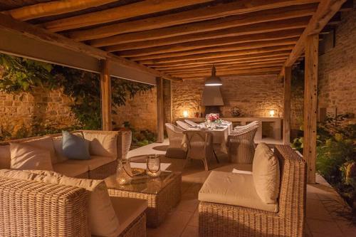 RadovaniVilla Charlotte for 14 persons with 73m2 Pool in Central Istria - Daily Housekeeping & Breakfast Service的户外庭院配有柳条家具和桌子